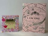 a pink box with a clock on it next to a pink box with a clock on it