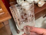 a person holding a wine glass in their hand