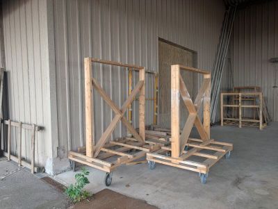three wooden pallets that are sitting in front of a building
