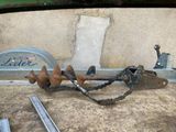an old rusted pipe and a wren sitting on the ground