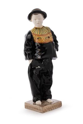 figurine of a man in a black suit and hat standing on a wooden base