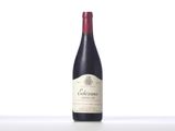 a bottle of red wine sitting on top of a table