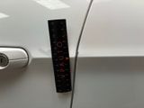 a sticker on the door handle of a white car