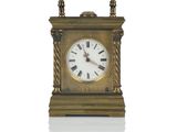 a gold clock with roman numerals on it