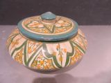 a small bowl with a lid on a table