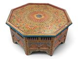 a close up of a wooden table with a colorful design on it