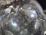 a glass vase with a heart shaped decoration on top of it