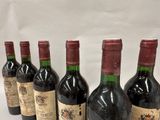 six bottles of wine are lined up in a row on a table