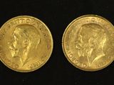 a close up of two gold coins on a black surface
