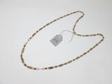 a close up of a gold chain with a tag on it