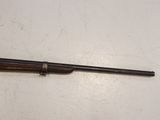 an old rifle is laying on the floor next to a wall