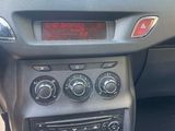 a car dashboard with a clock on it and a cat sitting on the dash