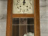 a clock that is sitting on the floor in the room