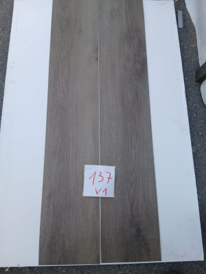 two pieces of wood are sitting on the ground next to each other