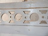 a close up of a wooden bench with holes in it