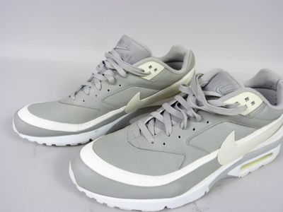 grey and white nike air max sneakers on a white background
