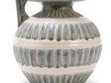 a blue and white vase with a handle on a white background