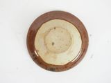a brown and white plate on a white surface