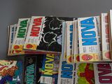 a lot of comic books stacked on top of each other