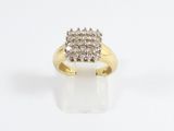 a close up of a diamond ring on a white surface