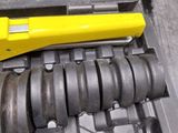 a yellow tool that is laying on top of a tool case