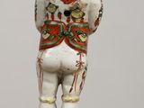 a figurine of a man standing on a marble base