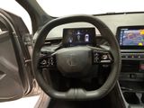 the interior of a car with a steering wheel, dashboard, and display screen