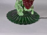 a green glass lamp with a bunch of grapes on it