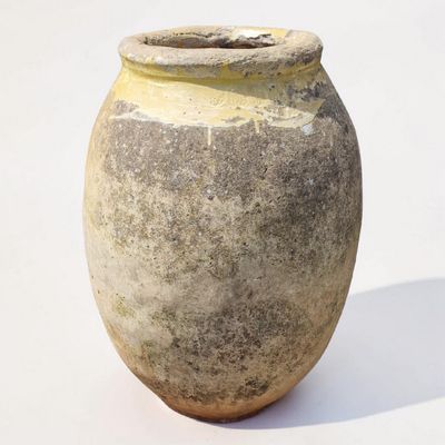 a large clay pot sitting on a white surface