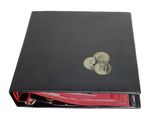 a close up of a book with a coin on top of it