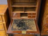 a desk with a drawer and a bookcase on it