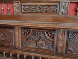 a wooden bench with carvings on it in a room