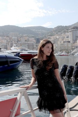 a woman that is standing on a boat in the water