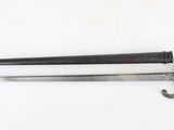 an old sword with a wooden handle on a white surface