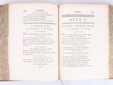 an open book on a white table with writing on it