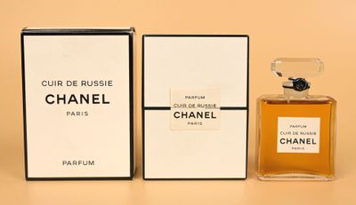 a close up of a bottle of perfume next to a box