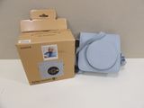 a box with a picture of a baby in it next to a camera
