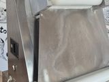 a pizza cutter sitting on top of a counter in a kitchen