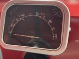 a close up of a speedometer on a red car