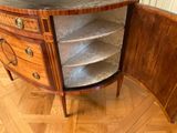 a small cabinet with a marble top in the corner of a room