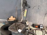 a machine that is sitting on the ground next to a tire
