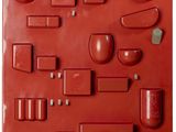 a close up of a red plastic mold with different shapes and sizes