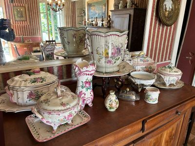 a large collection of china on a table in a room