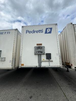 two trailers that are parked in a parking lot