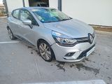 the silver car is parked in the parking lot outside of the building