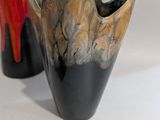 two vases sitting next to each other on a table