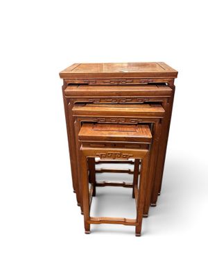 three wooden nesting tables sitting on top of each other on a white surface