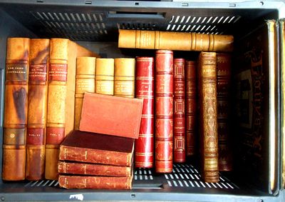 many old books in a metal box on the shelf