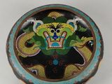 a decorative box with a dragon on it on a table
