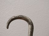 a silver colored umbrella with a decorative design on it